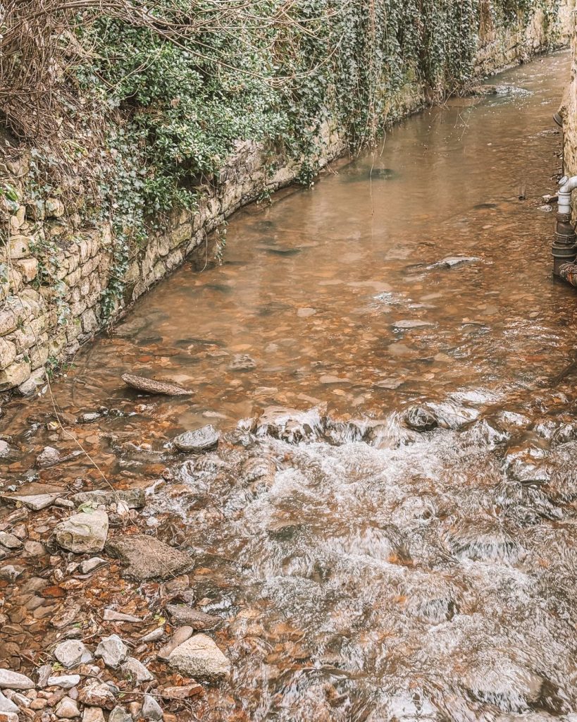 The River Lym flowing past the Town Mill in Lyme Regis and the start of the Uplyme walk