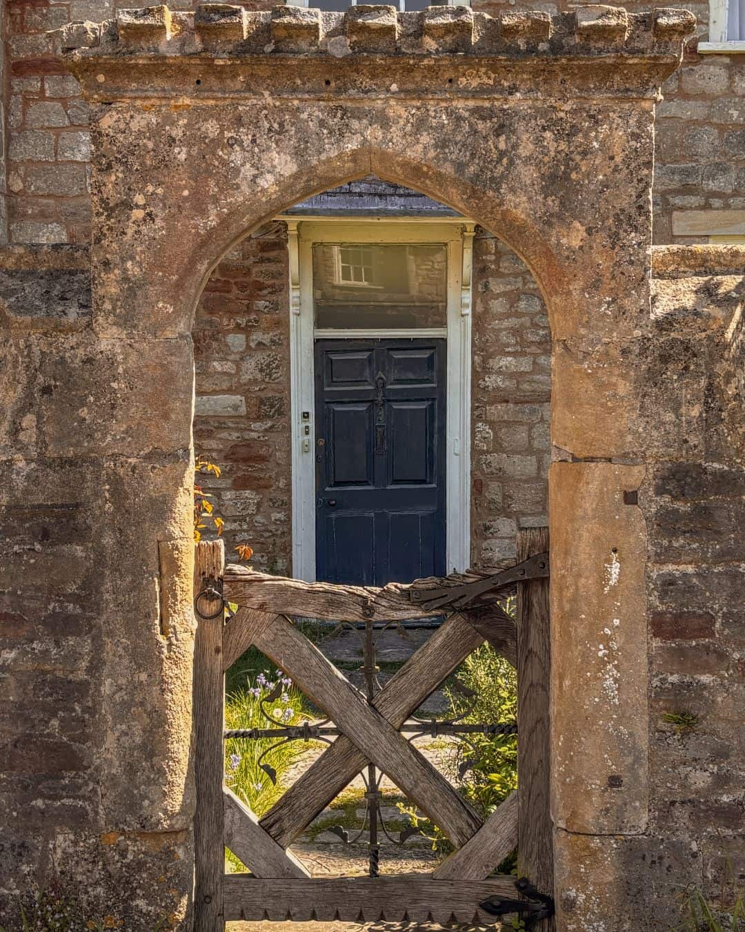 A blue door and archway in Vicar's Close, Wells in Somerset