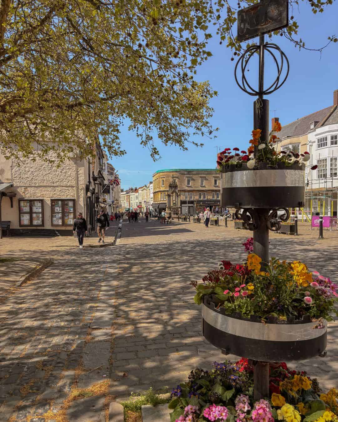 Flowers in bloom in Wells' Market Place on a beautiful April day