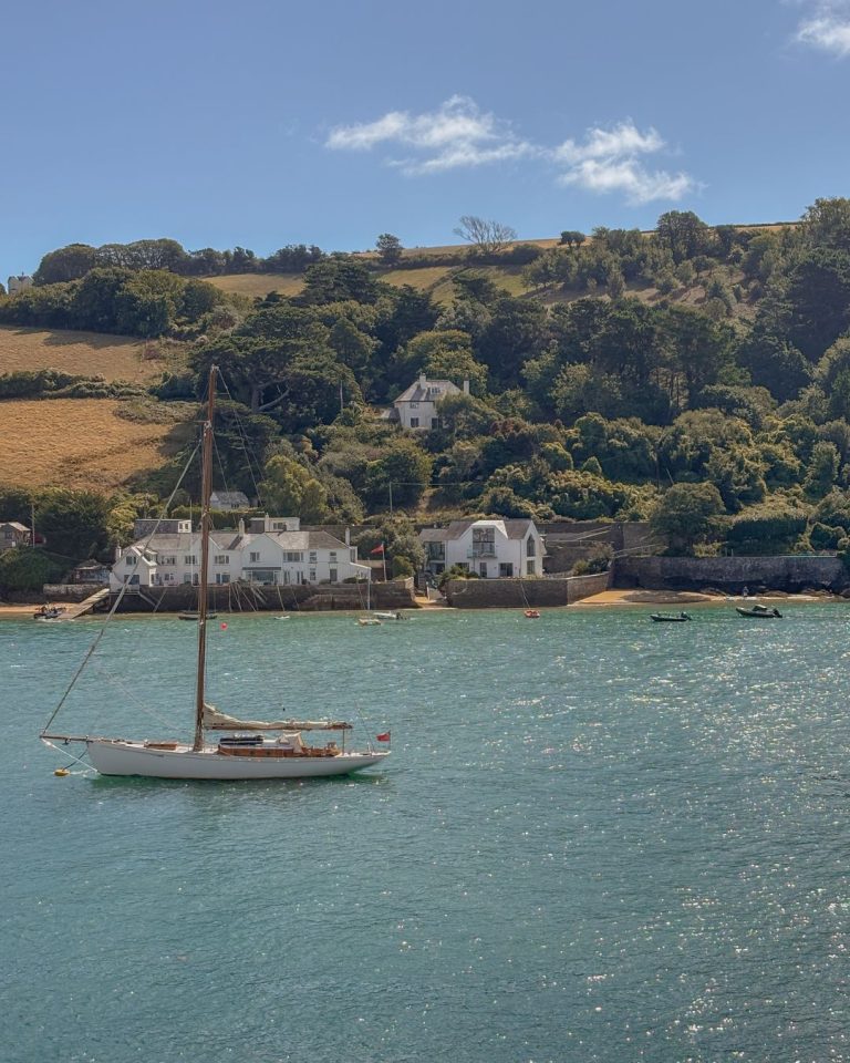 Salcombe water glistening on a sunny day with boat