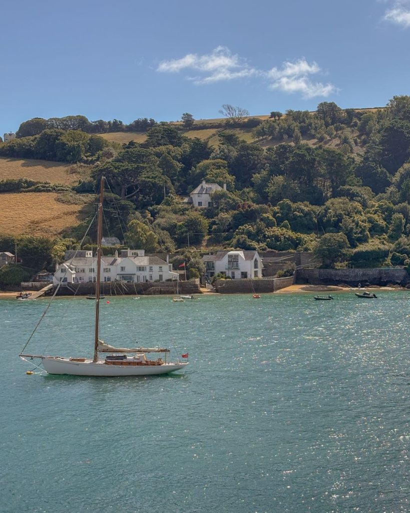 Salcombe water glistening on a sunny day with boat